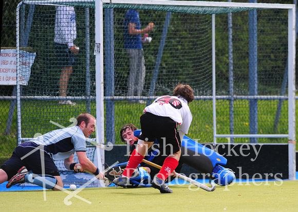 Annadale's Rory Capper shoots with Monkstown's Andy Ewington and David Fitzgerald defending