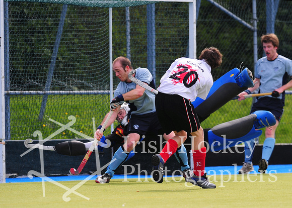 Annadale's Rory Capper shoots with Monkstown's Andy Ewington and David Fitzgerald defending